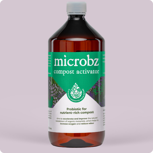 bottle of microbz compost activator living liquid probiotic for breaking down compost, with graphic illustration