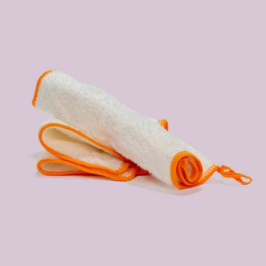 an image of two microbz bamboo cleaning clots, they are white with an orange edge